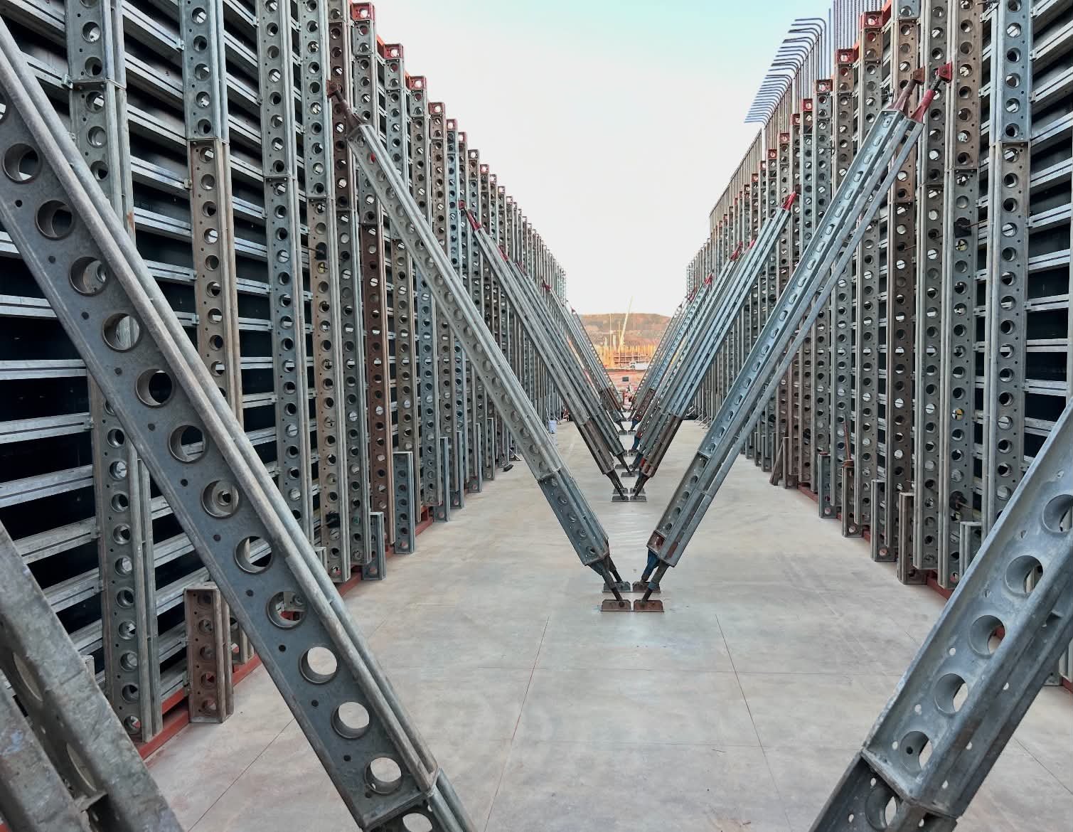 Rows of modular steel formwork stacked in the yard