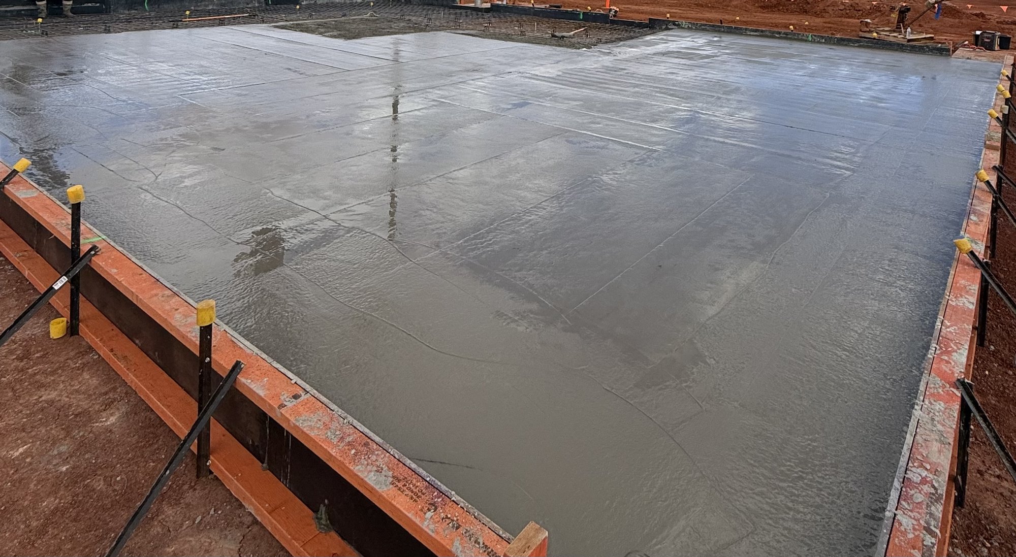 Freshly poured concrete slab being finished