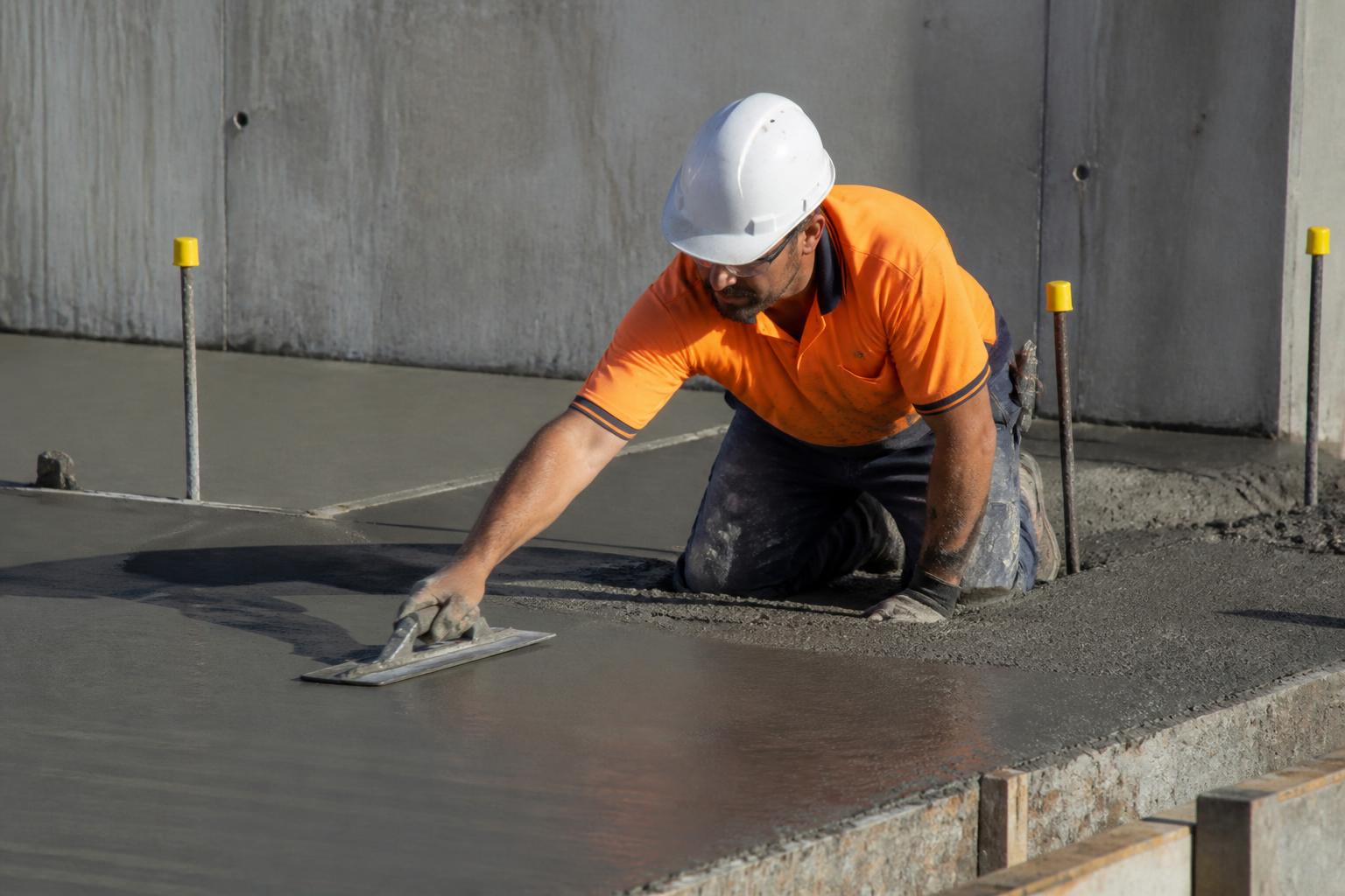 Concreter power-trowelling a fresh slab on site